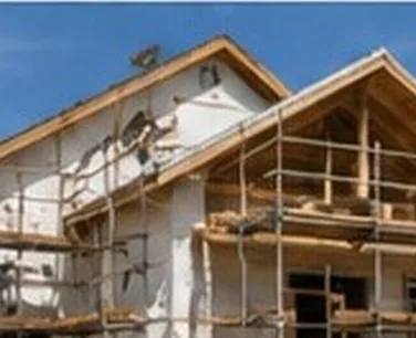 Roof and exterior wall being rebuilt