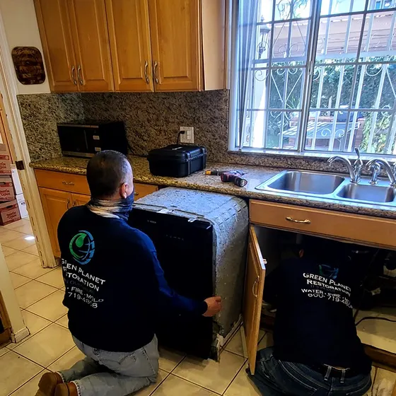 Crew removing water-damaged cabinets, Central LA