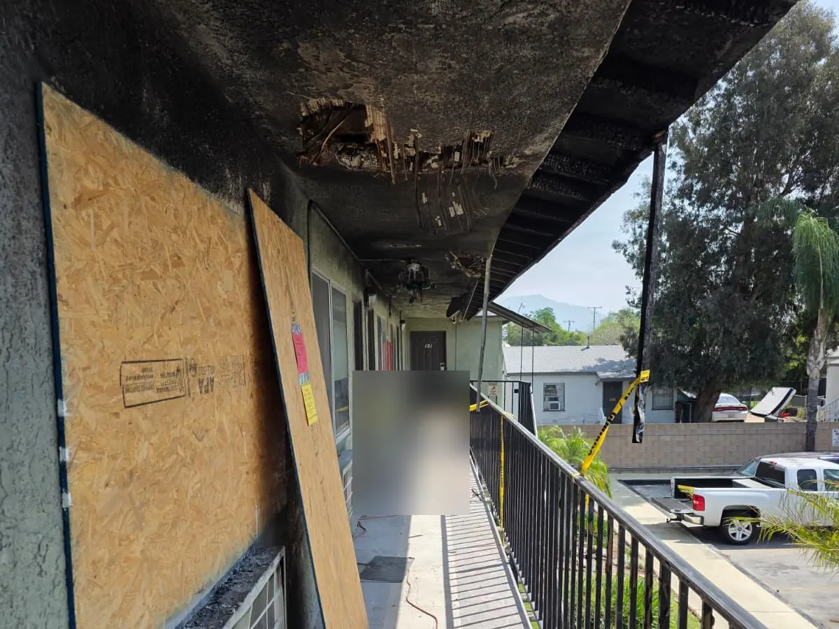 Crew boarding up a damaged window