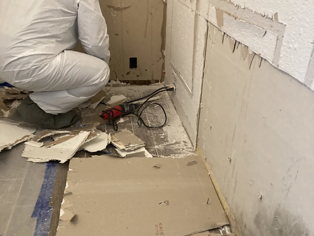 Technician in protective gear during mold remediation