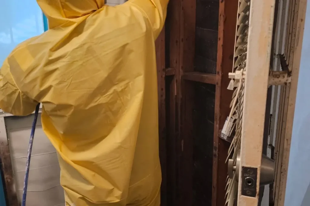Technician in protective suit and respirator