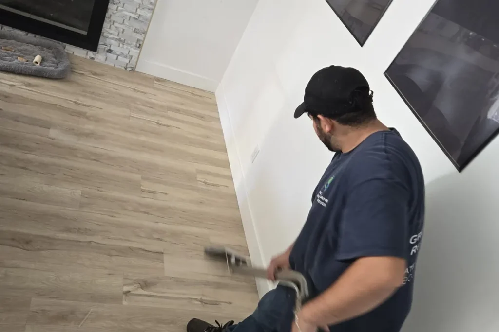 Technician extracting water from flooring
