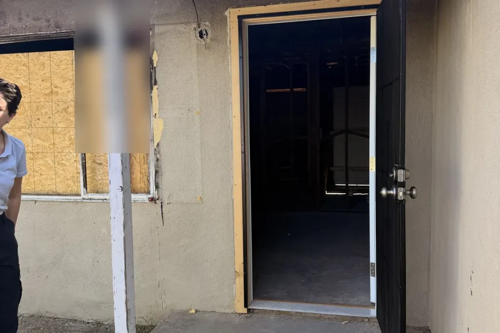 Plywood board-up over a broken window
